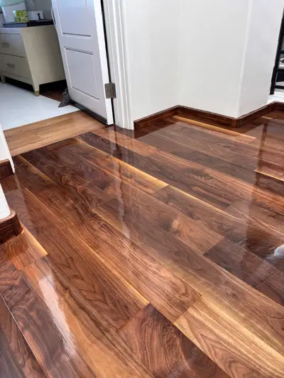 Dark walnut-toned hardwood floor with a high gloss