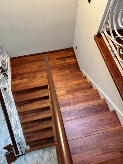 Refinished staircase with a dark hardwood runner