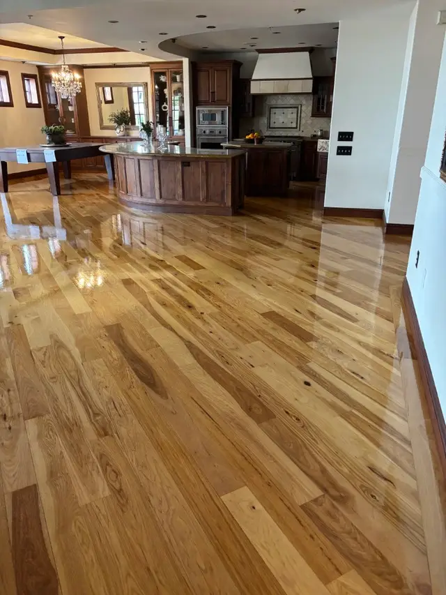 Glossy refinished hardwood in an open kitchen and living area
