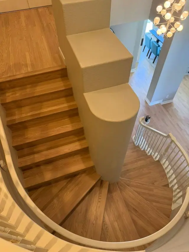 Curved hardwood staircase refinished in a warm tone